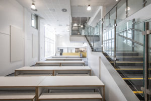 Photo of a staircase and a dining area in the Leigh Academy Blackheath building.