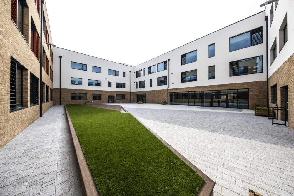 Photo of the exterior of the Leigh Academy Blackheath building, showing an outdoor space.