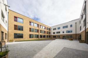 Photo of the exterior of the Leigh Academy Blackheath building, showing an outdoor space.
