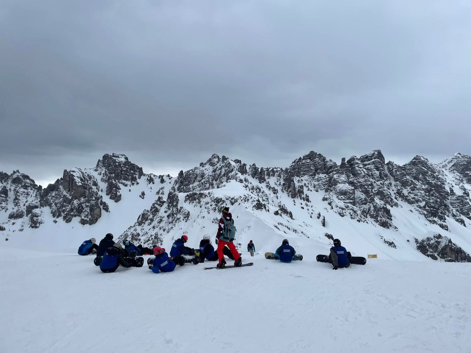 LAB students can be seen perched on the snowy ground, looking up at the mountains whilst on a Ski Trip in Austria.