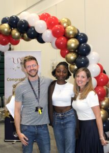 Student stood with two staff members on results day