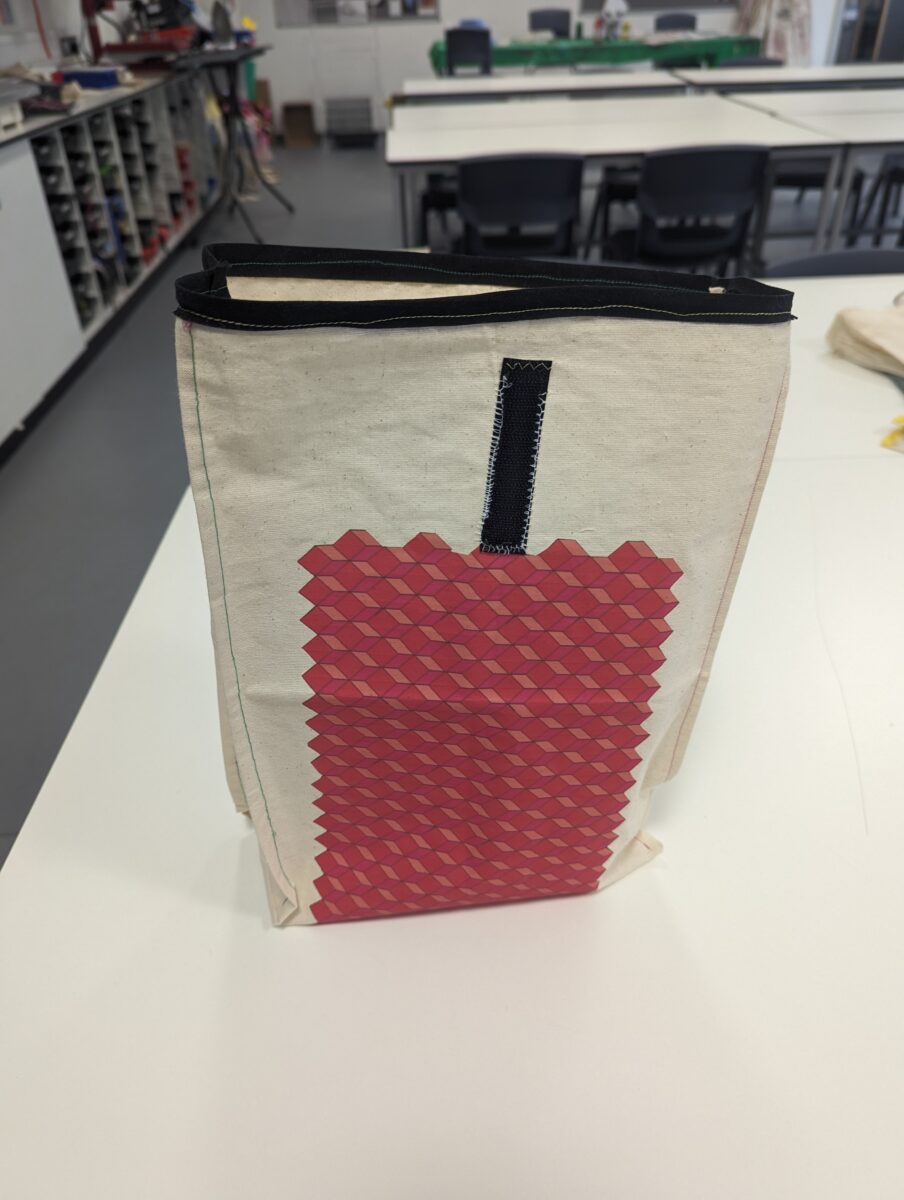 DT Year 8 Students Lunch Bag - a brown canvas bag with a red geometric pattern