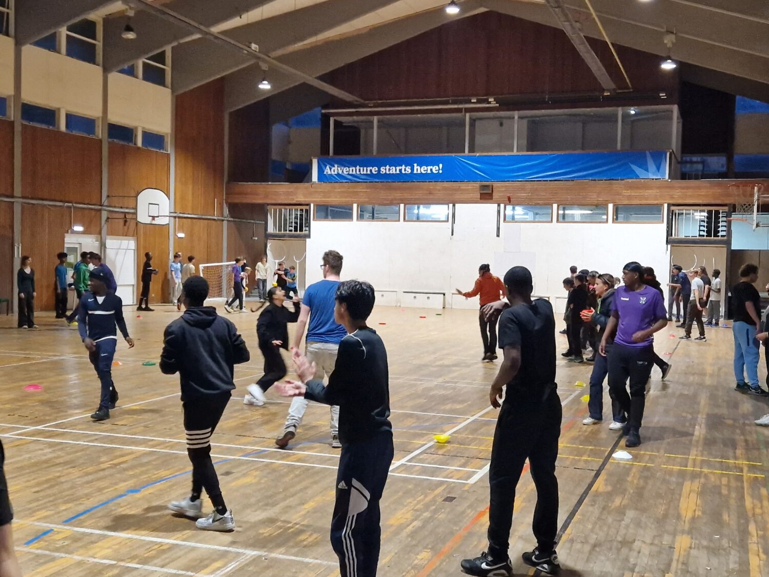 A large group of students in a sports hall