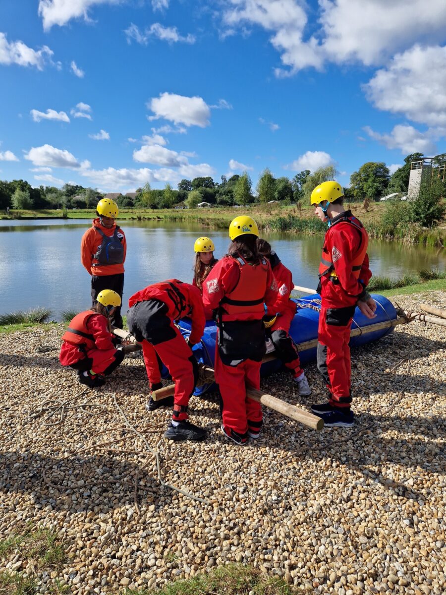 Students stood around a raft made with barrels