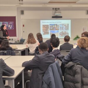 A group of students at desks watching a presentation