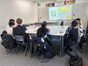 Students at a desk talking